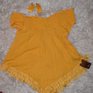 Yellow off the shoulder top with earrings